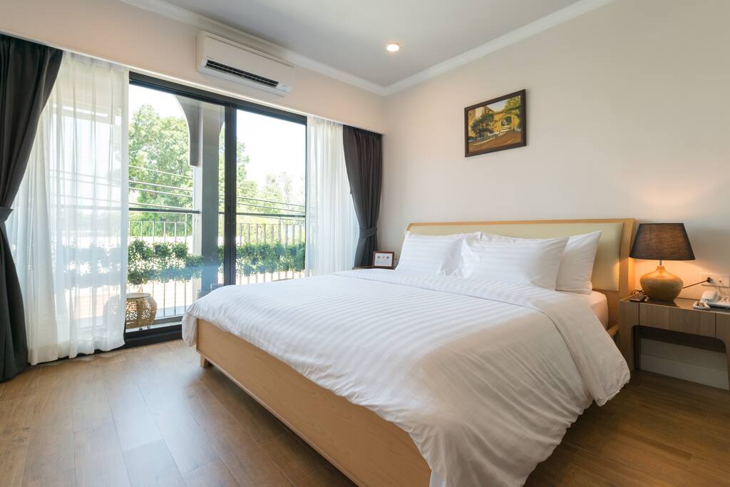 Room 301 - Comfortable king size bed with balcony.