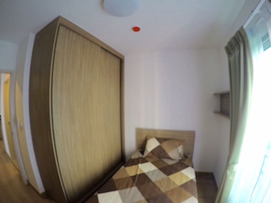 the second bedroom with a single bed