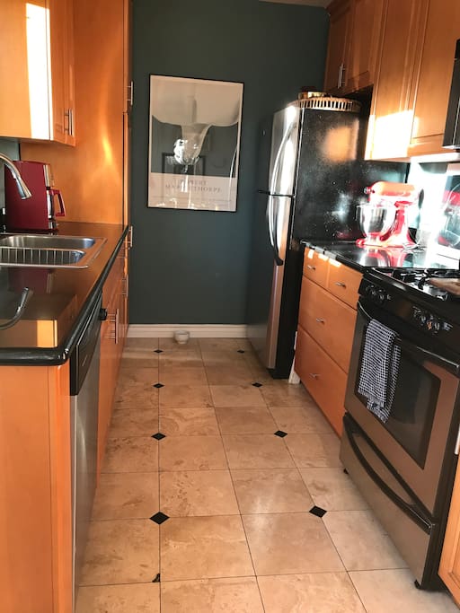 Fully stocked modern kitchen. Oven, stove, refrigerator, coffeemaker, dishwasher, garbage disposal, dishes, silverware, stemware and pots and pans