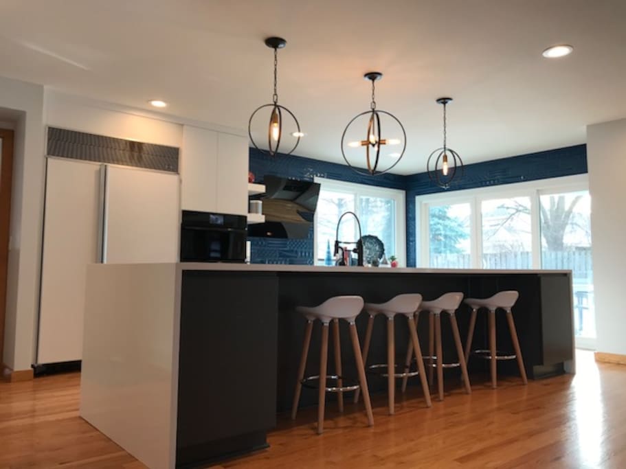 Gourmet Kitchen with massive island, commercial sink, Subzero refrigerator and professional grade appliances.