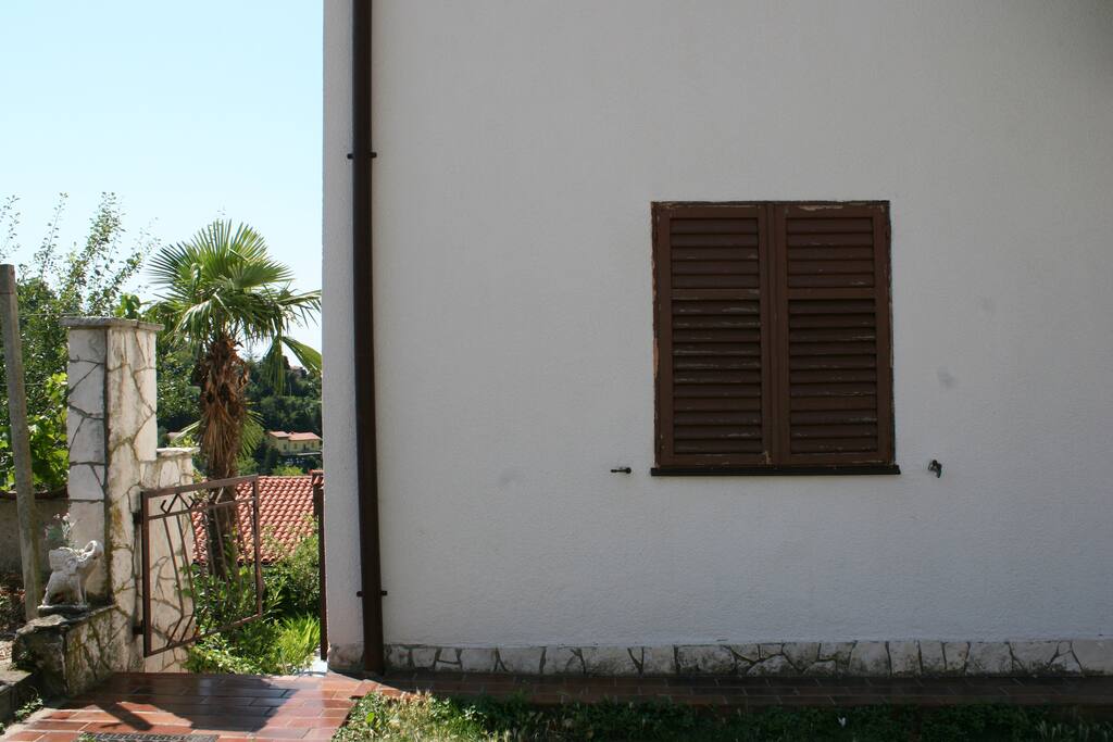 On the left side of the house are stairs that lead to the entrance to the apartment
