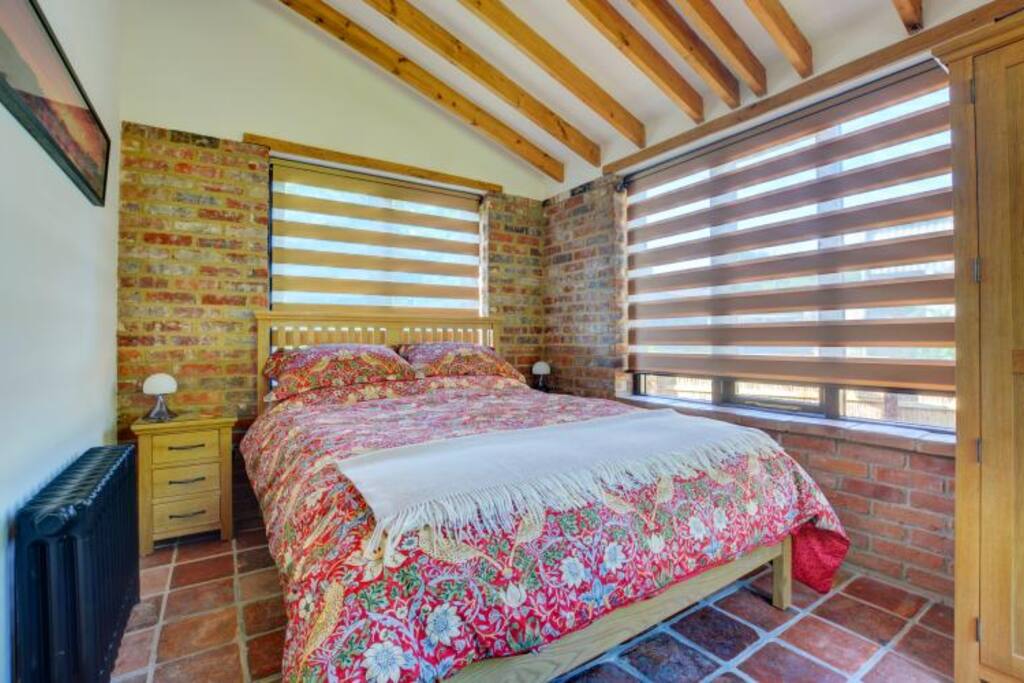 Comfy king size bed with luxury goose down duvet and Morris and Co bedding