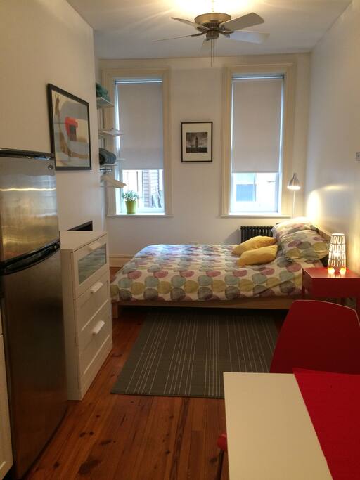 Queen size bed with reading lamps. This photo has the artwork up!