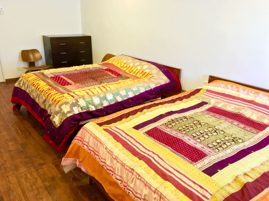 Bedroom 1. There are 2 x queen-sized beds. Sleeps 4. Room is air-conditioned & has a ceiling fan too.