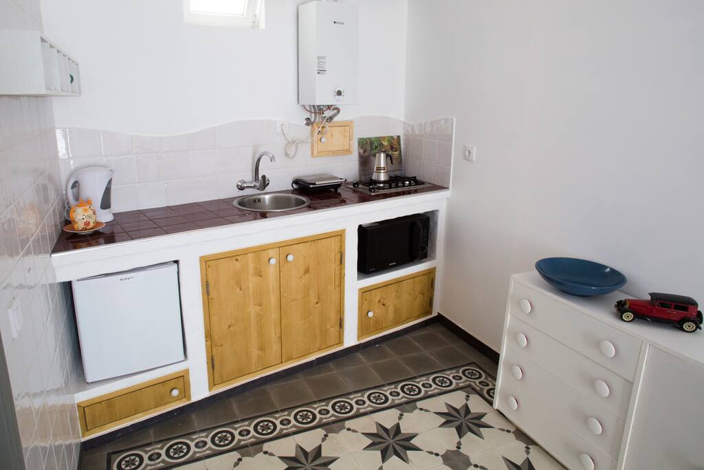 kitchen with refrigerator, microwave/oven, electric kettle, pannini grill and espresso coffee maker