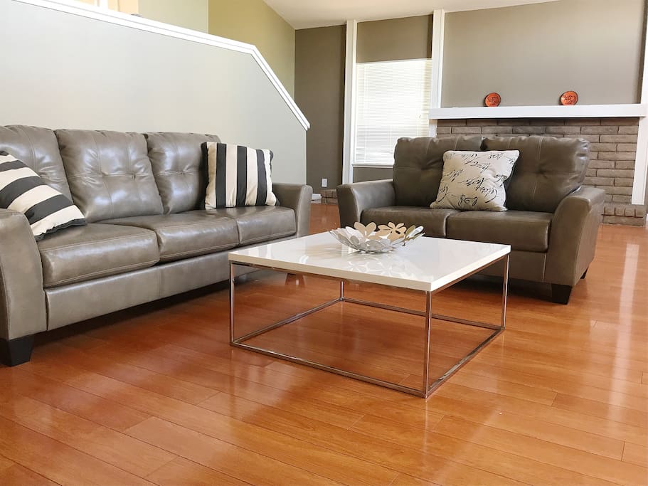 Living room has two comfortable leather sofa. It has a lot of open space