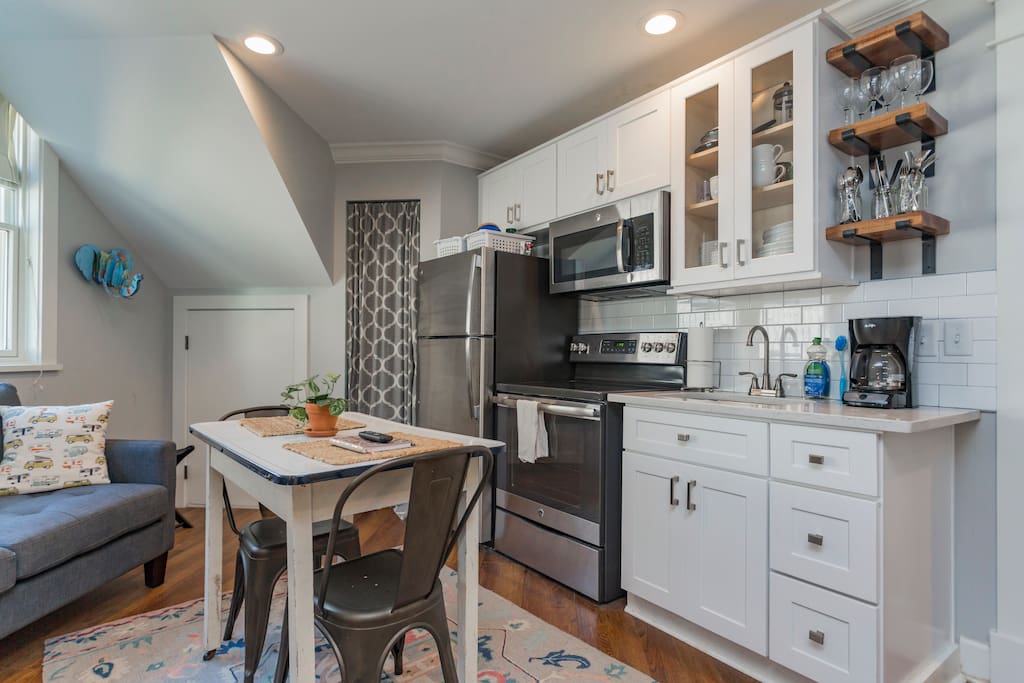Kitchen includes full-size refrigerator and range, microwave, coffeepot and kettle, dishes, flatware, basic pots & pans and other kitchen essentials.
