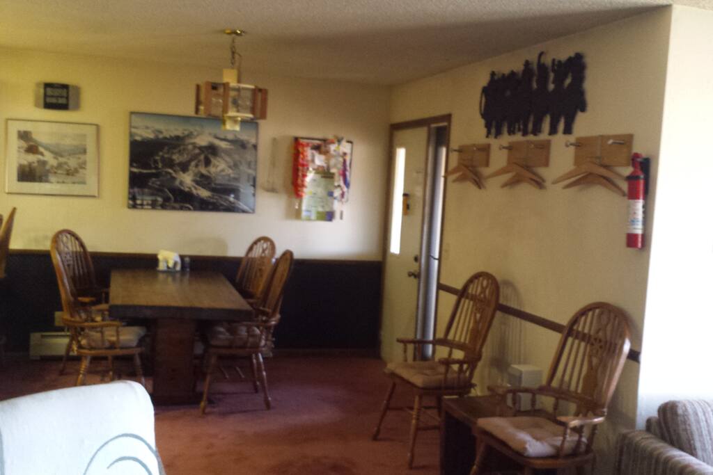 Entry area, Dining area, coat hangers and lots of chairs.
