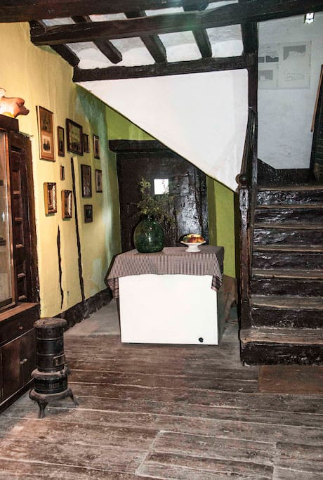 Typical entrance of a village house in the Pyrenees. Parquet floor wood of three centuries ago. Access to the room is rented