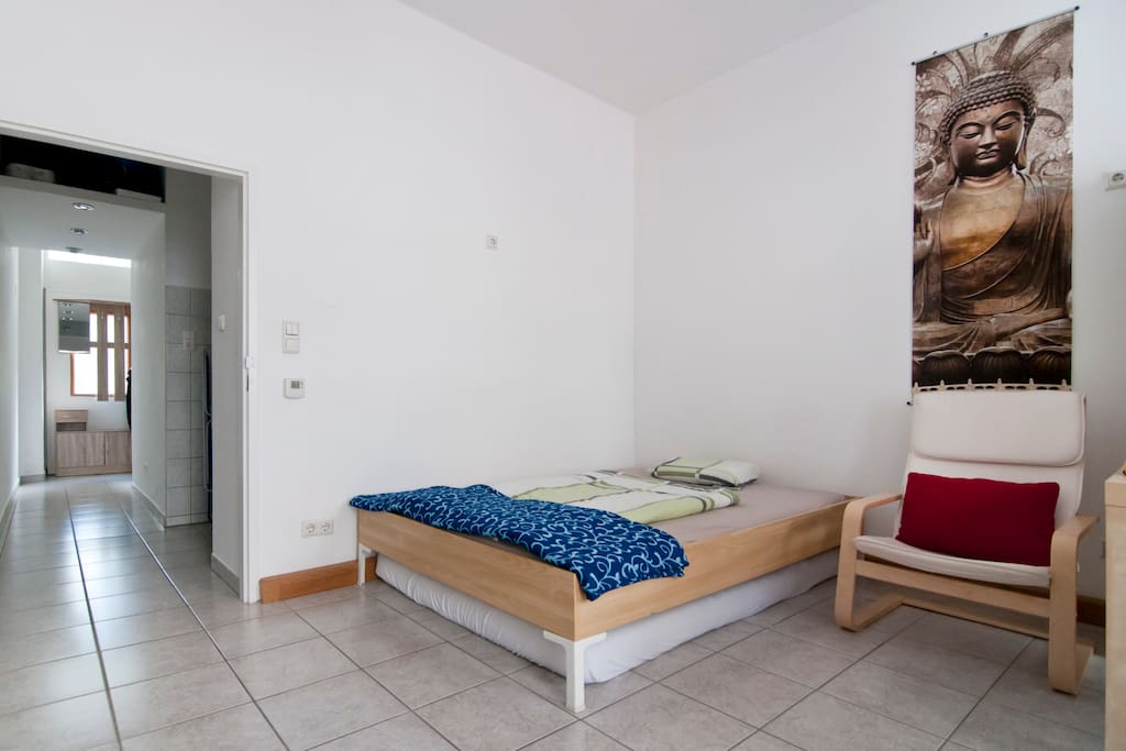 The king-size-bed with view to the long corridor.