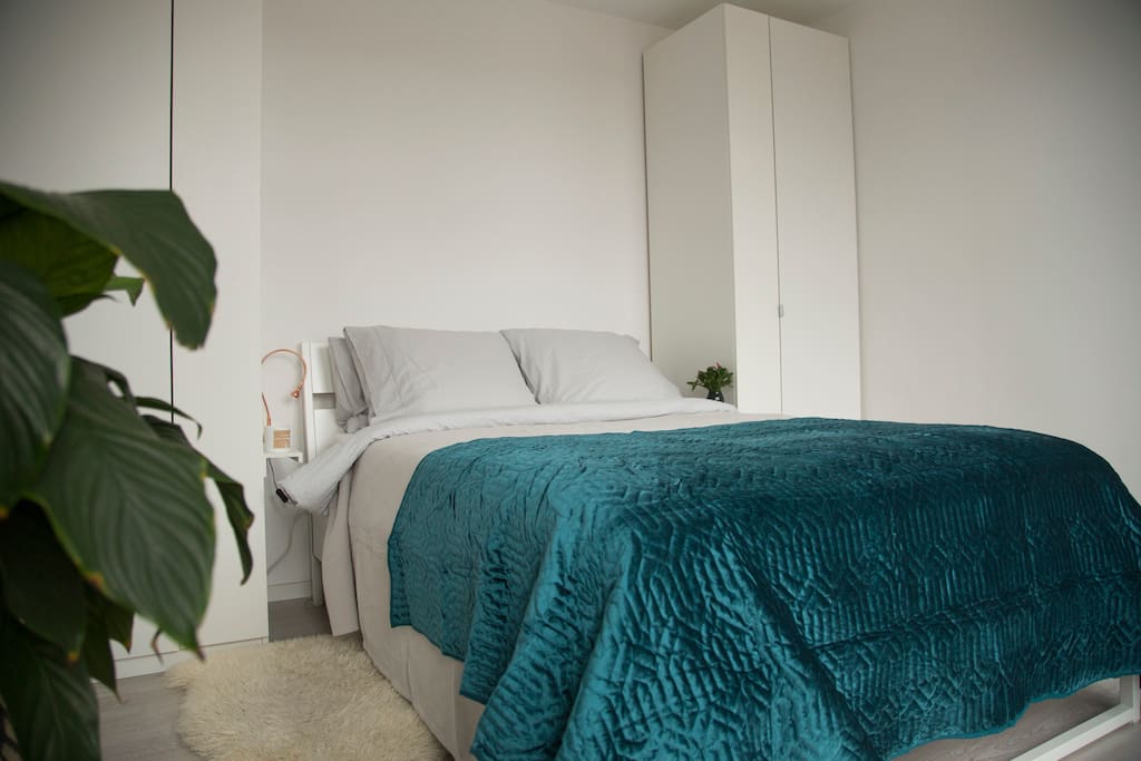 1st bedroom with a double bed and a French balcony overlooking the street.