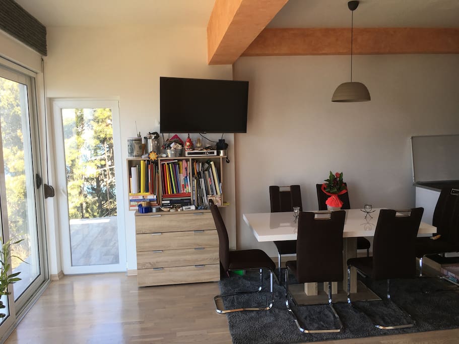 Main Dining Table and small Terras on the left corner where you can sit outside during dinner as well. Further a LG TV with internet connection and 60 Channels