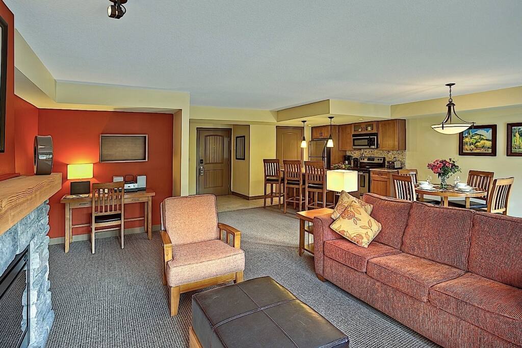 This spacious living area is features a cozy fireplace, a flat-screen TV and a DVD player