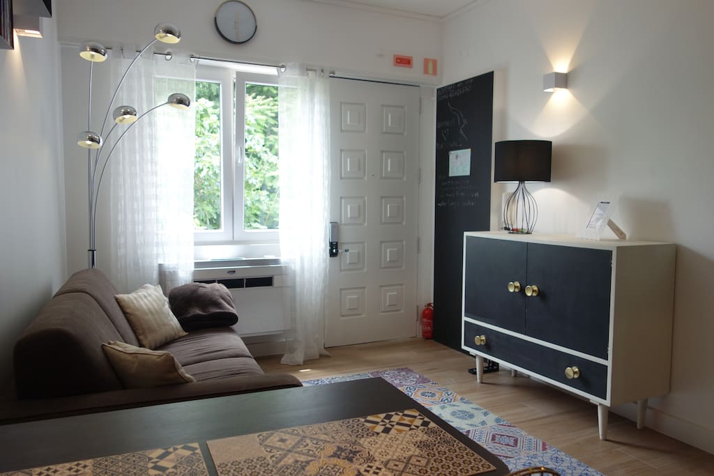 living room with a double sofa-bed and air conditioning