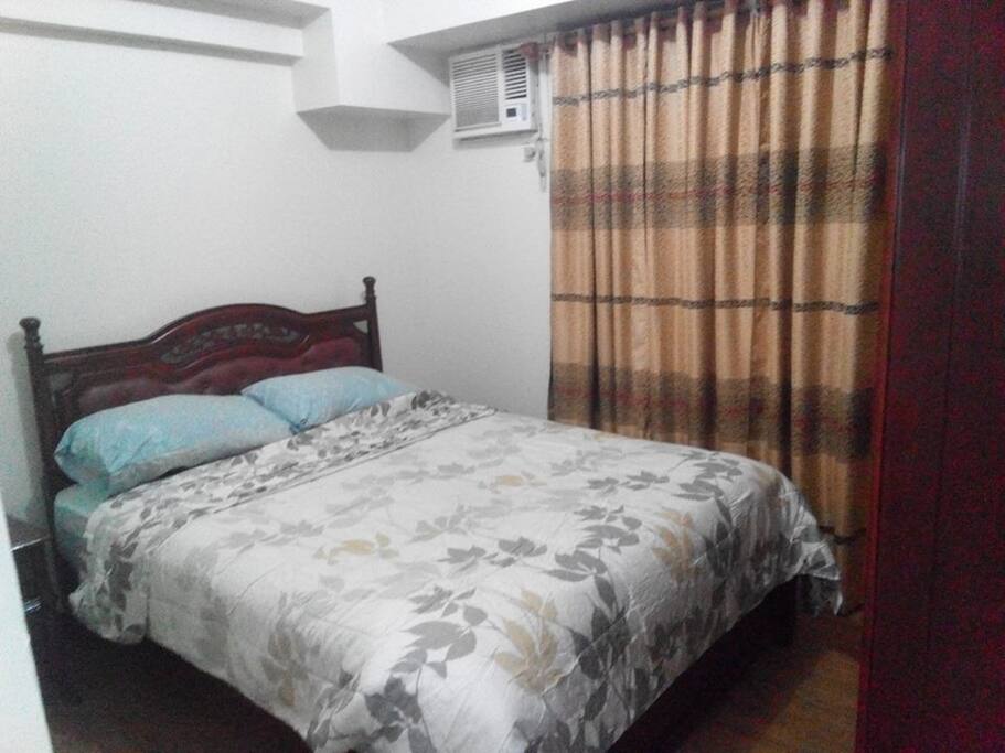 Queen size master's bedroom with private bathroom equipped with water heater.