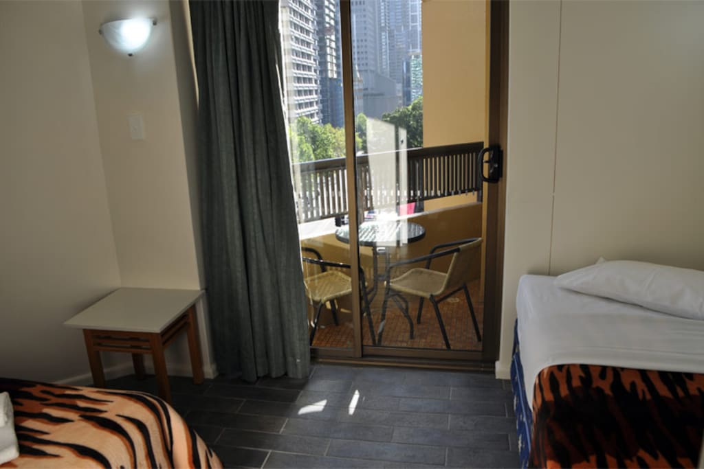 Second bedroom with 2 single beds and 1 single trundle bed, plus second balcony