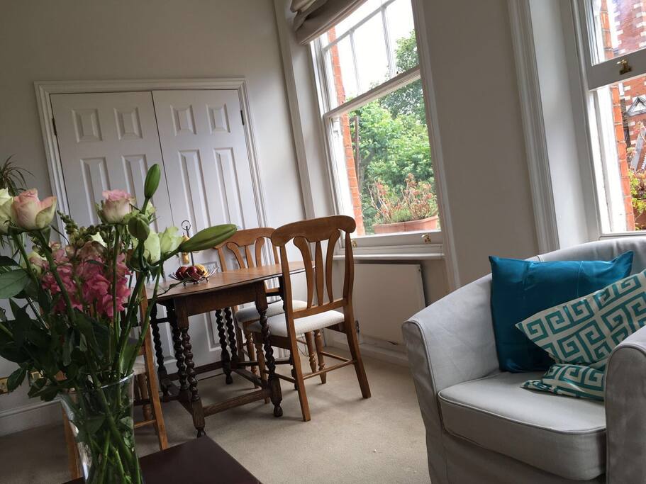 Dining table and doors that allow living room to open up into 2nd bedroom