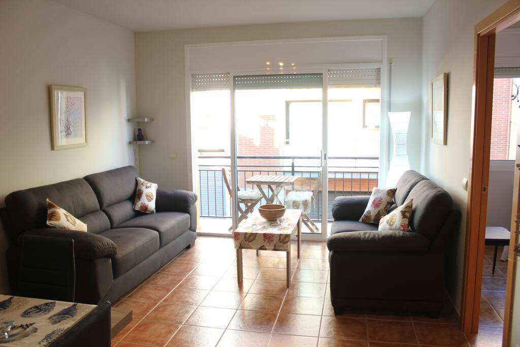 Spacious living area with balcony and..