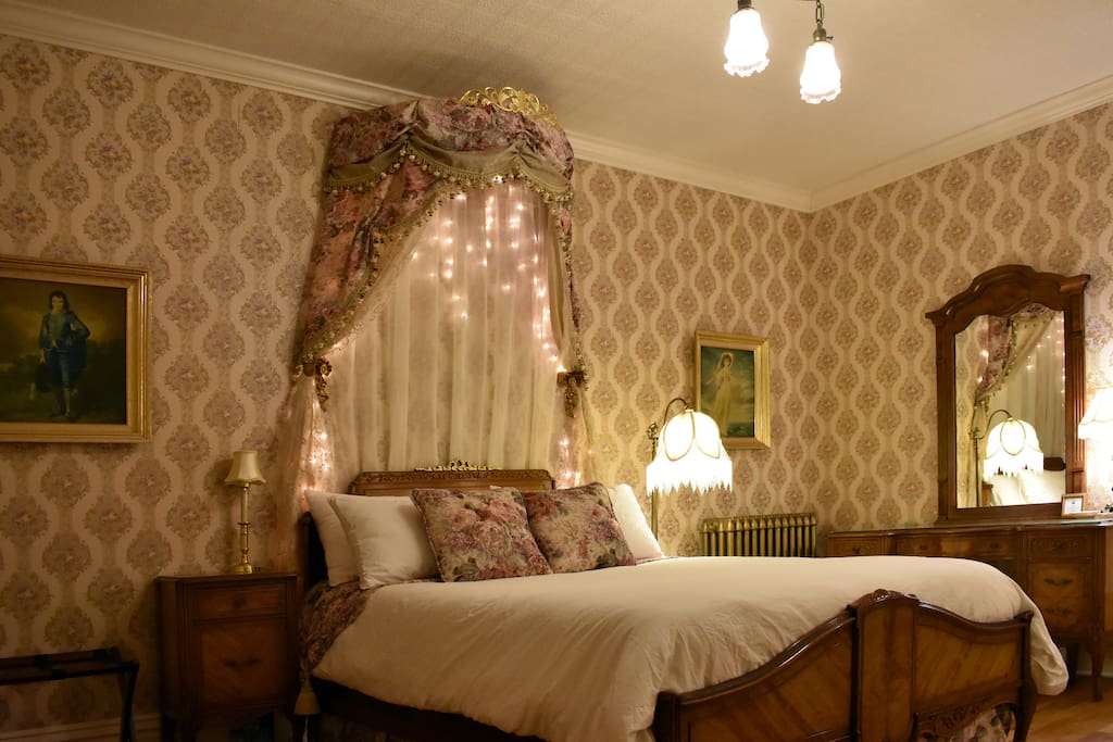 Beautiful room paying homage to true Victorian tastes with its circle canopy and tasseled drapes. This firm antique full bed has soft cotton sheets.