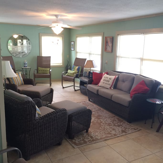 Downstairs living area open to kitchen & dining with water view.