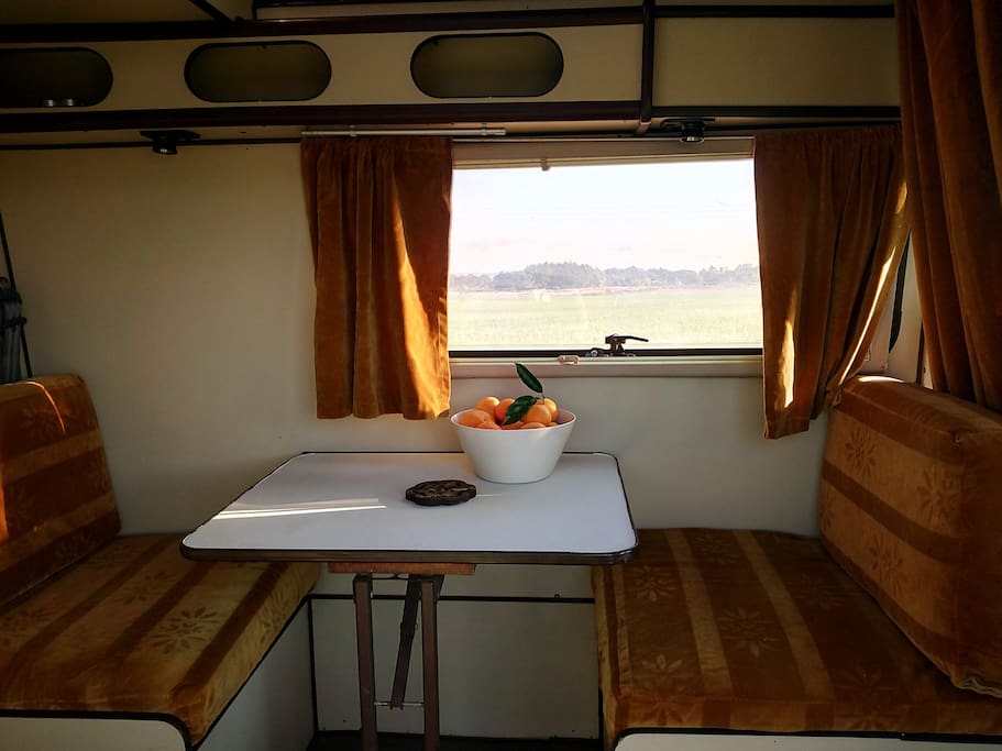 A table and two seats that transform into a bed, adult size