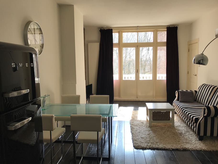Living room facing the park with open plan kitchen