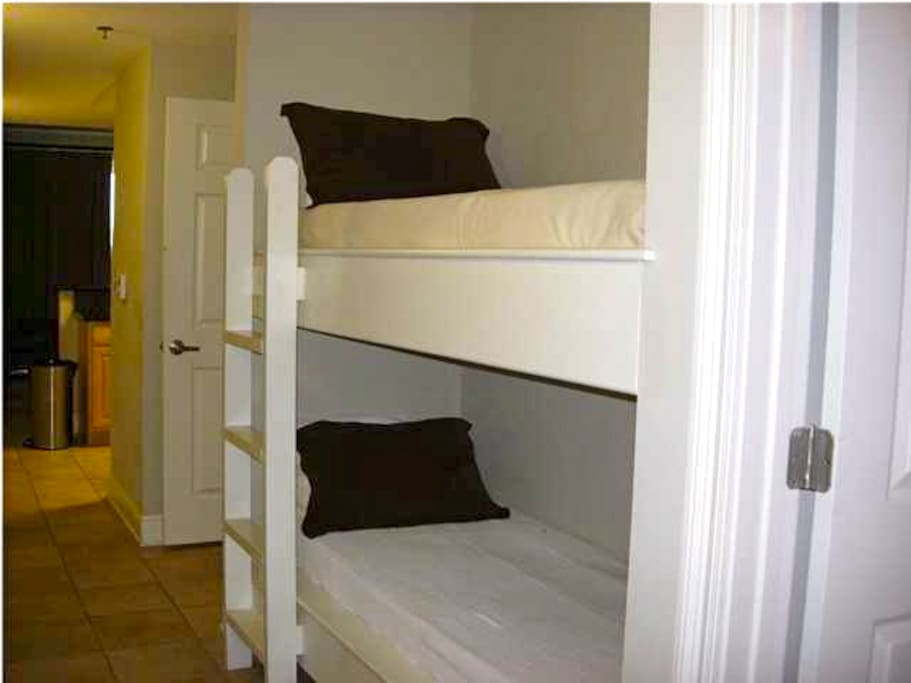 Two full size bunk beds in the hallway.