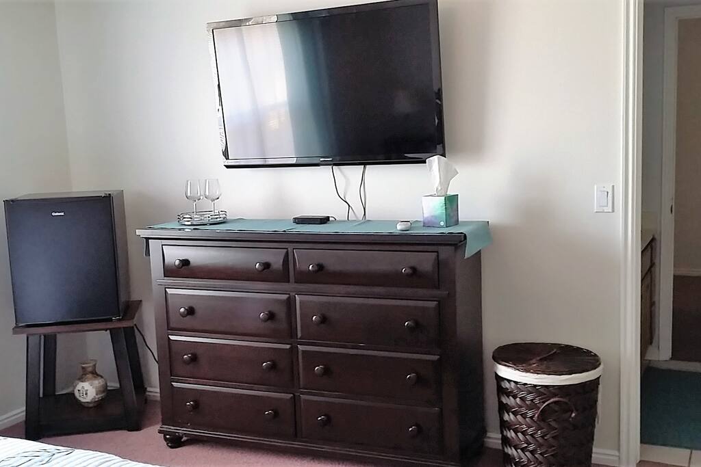 Large flat screen tv and refrigerator.