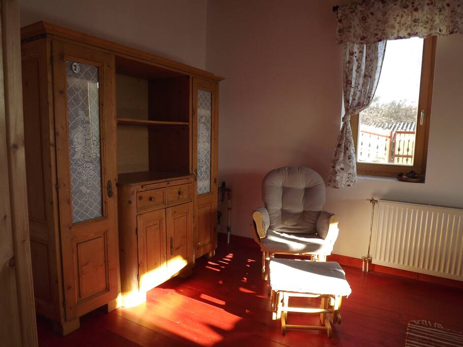 Wardrobe, rockingchair and table also in the room