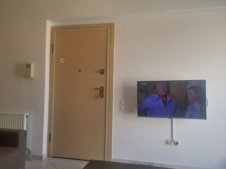 Living Room, Equipped with two new couches, new flat screen TV, new dinning table and Air Condition Unit.