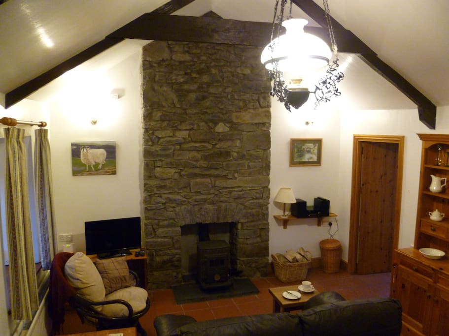 Charming character sitting room with cosy log burner