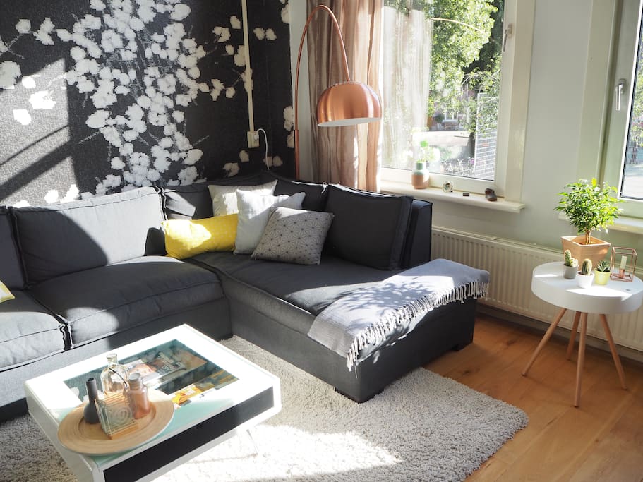 Updated furniture with new couch, copper lamp and white-wood side table
