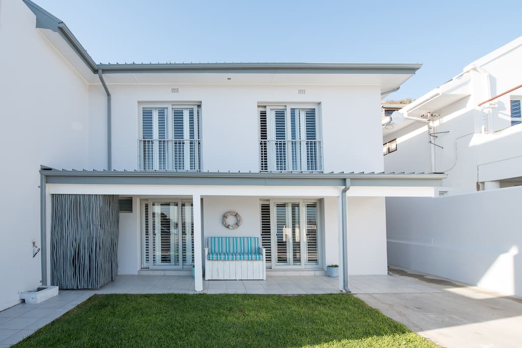 The seaside flat occupies the bottom floor with own private driveway and BBQ area