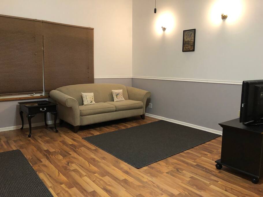 Comfy couch in the living room so you can relax and watch cable tv including HBO