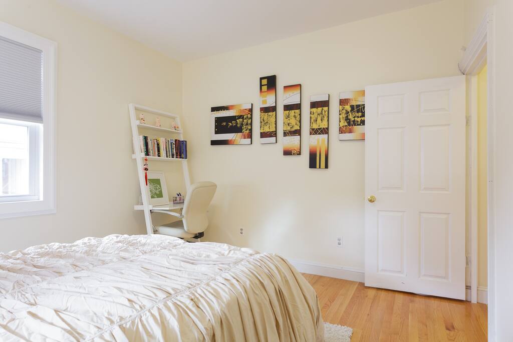 Bright and sunny bedroom with workstation.