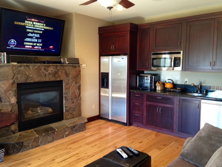 Living room/kitchen area and fireplace.
