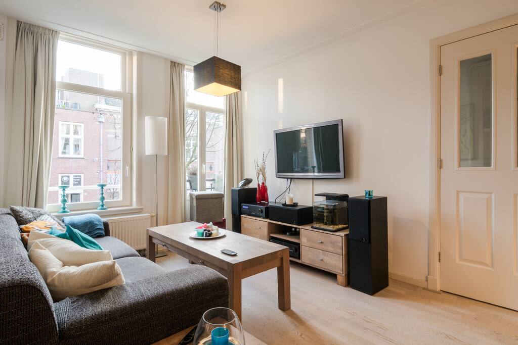 Relax in the spacious living room with a couch, coffee table, and TV.