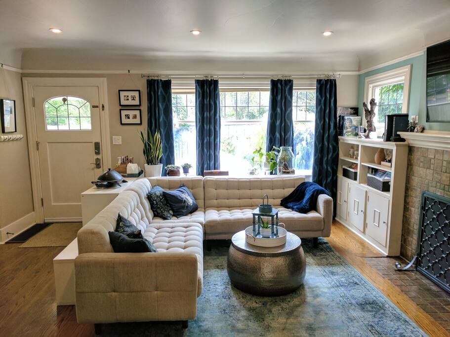 Front entrance, into living room with a sectional couch, TV, non-working fireplace. Samsung smart TV, Xbox 360, Wii, Roku, Chromecast.