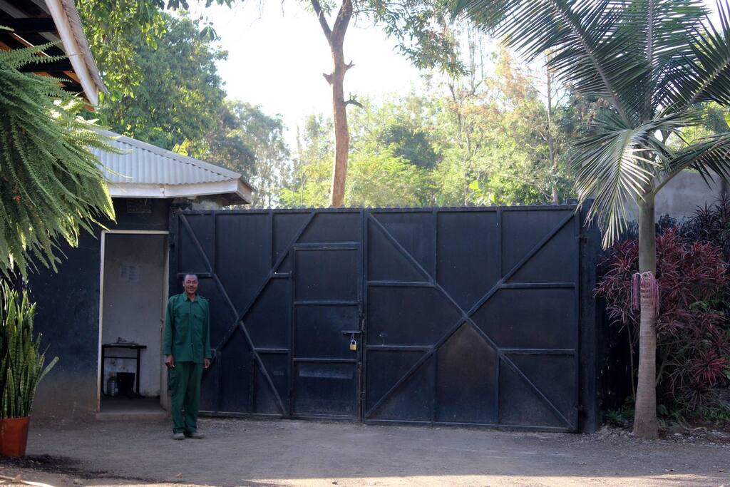 compound is secured by a wall and a guard is on duty 24 hours a day