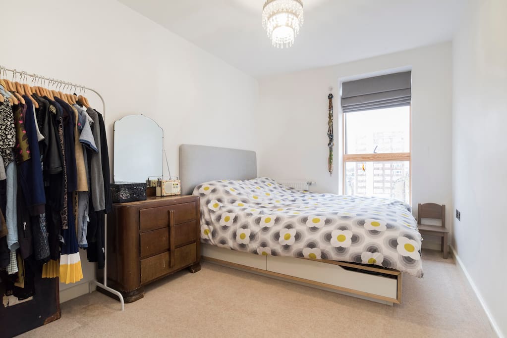 Comfortable bedroom with king size bed and hanging space for guests clothes.
