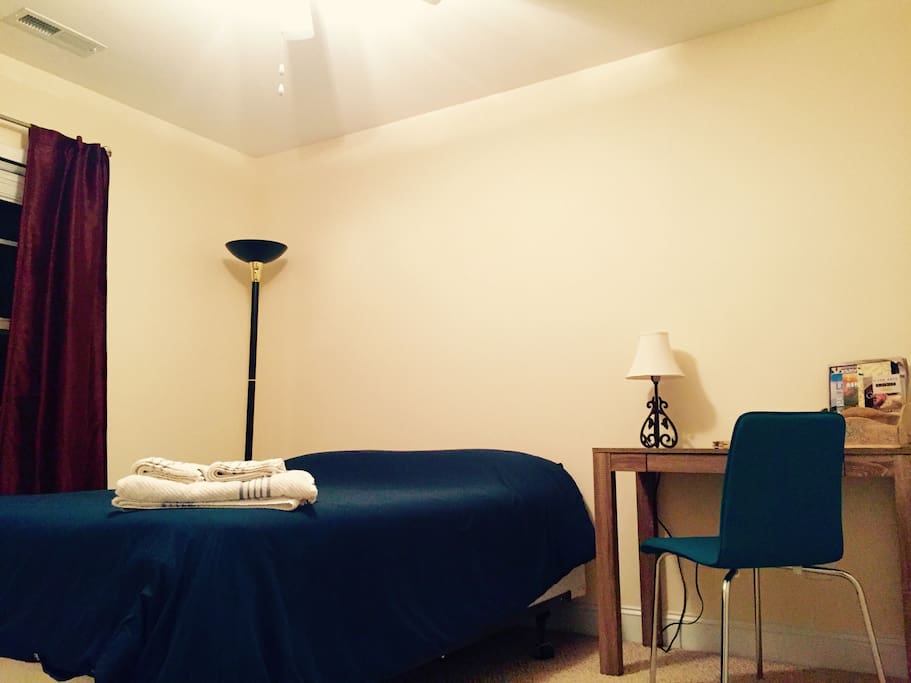 Comfortable queen size bed, equipped with a writing desk