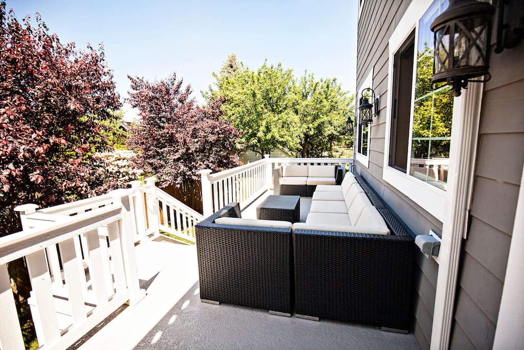 Back deck located off open concept family/kitchen with awesome seating area for 6-8! Deck area also includes an umbrella (not pictured)