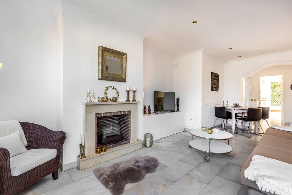 Ample and well appointed living room with fireplace apartment with sea views for rent by Puerto banus with pool