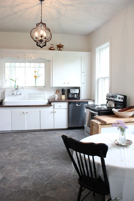Bright and spacious country kitchen with antique cast-iron sink and all new appliances.