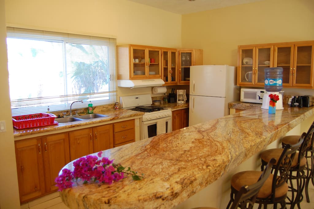 There is a large kitchen with all appliances and utensils.