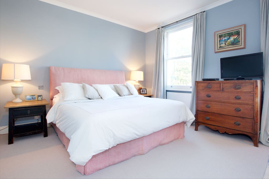 The elegant master bedroom with a comfortable Super king size bed, television and writing desk (out of shot).