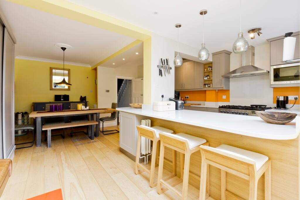 Kitchen with dining area and large doors onto garden