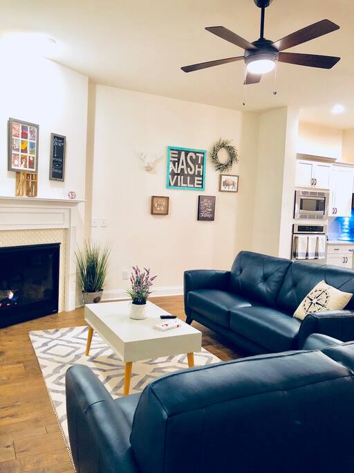 This modern living room which is open to the kitchen. Its the perfect place to wind town after a long day of touring Nashville. This is a public space.