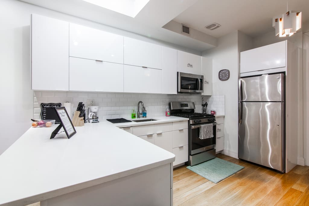Brand-new kitchen with hardwood floors, cabinets, and microwave