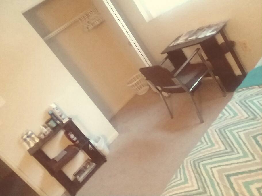 Small bookshelf, desk, chair, ironing board, laundry basket and hangers available in room